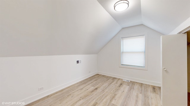 bonus room featuring light hardwood / wood-style floors and vaulted ceiling