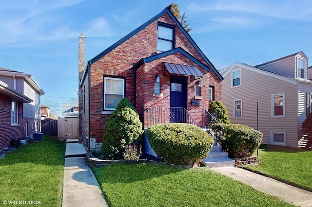 view of front facade with a front yard and central AC unit