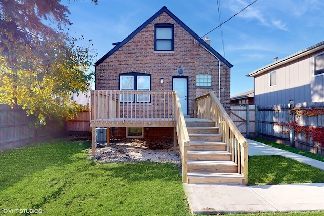 rear view of house with a lawn, a wooden deck, and cooling unit