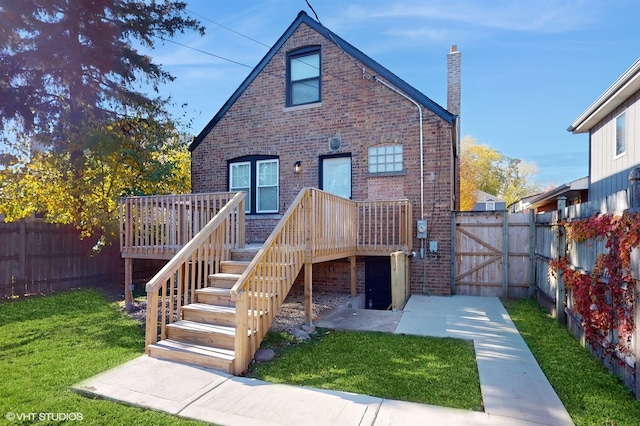 back of property with a lawn and a wooden deck