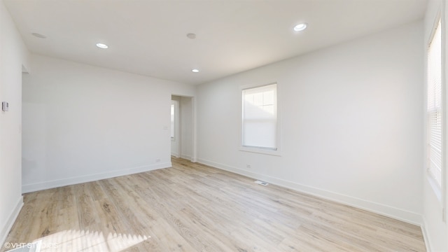 empty room with light hardwood / wood-style flooring