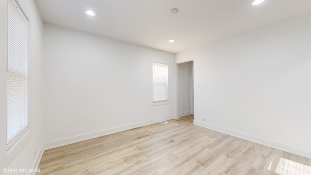 empty room with light hardwood / wood-style floors