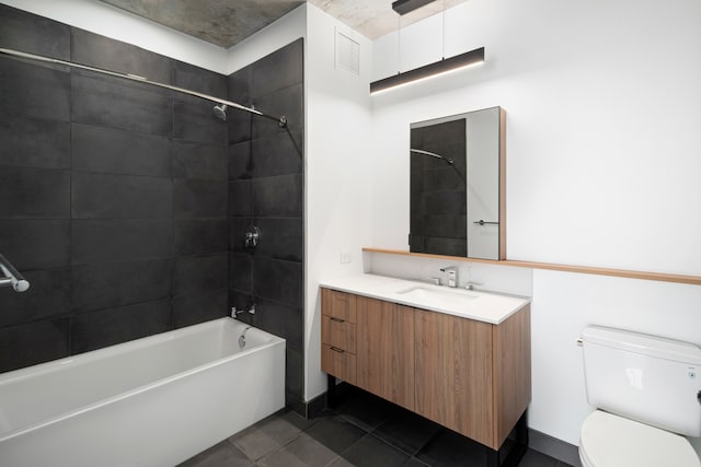 full bathroom with tile patterned flooring, vanity, toilet, and tiled shower / bath