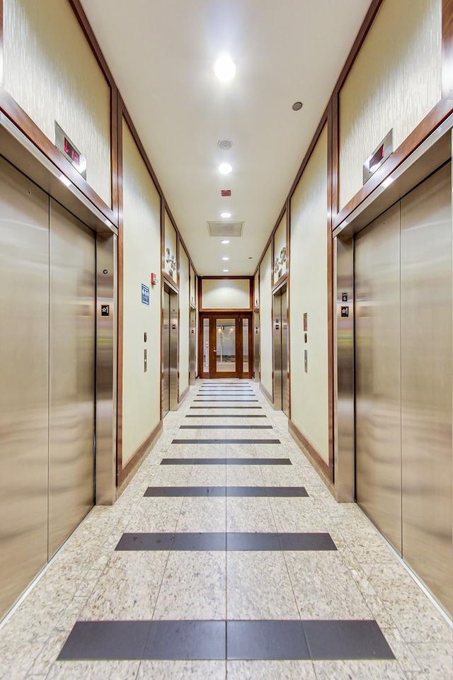 corridor featuring ornamental molding and elevator