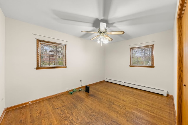 unfurnished room featuring hardwood / wood-style flooring, ceiling fan, and a baseboard radiator