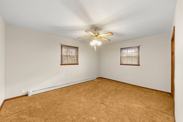 carpeted empty room featuring ceiling fan and a baseboard heating unit