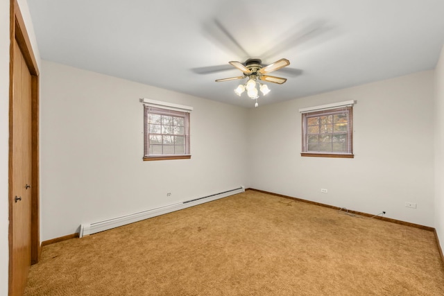 spare room featuring ceiling fan, light colored carpet, and a baseboard radiator