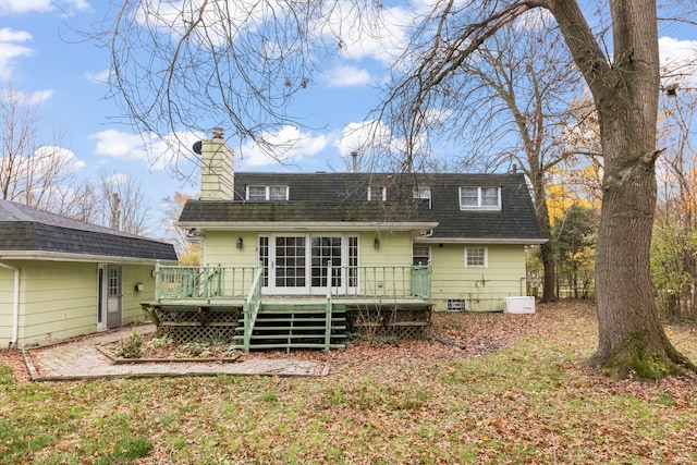 rear view of property with a wooden deck