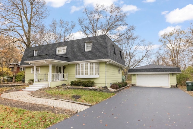 view of front of property with an outbuilding, a garage, and covered porch