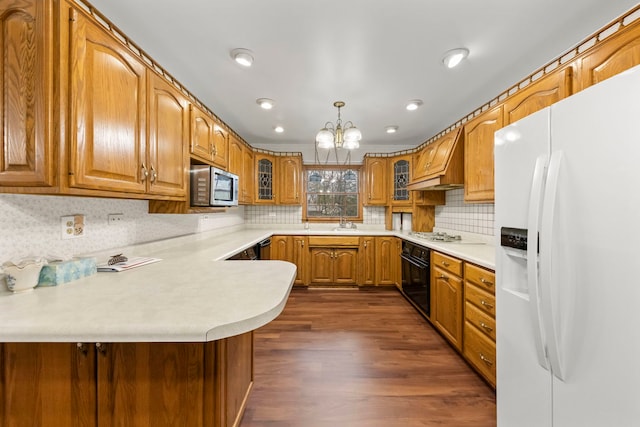 kitchen with white appliances, premium range hood, decorative light fixtures, dark hardwood / wood-style flooring, and kitchen peninsula