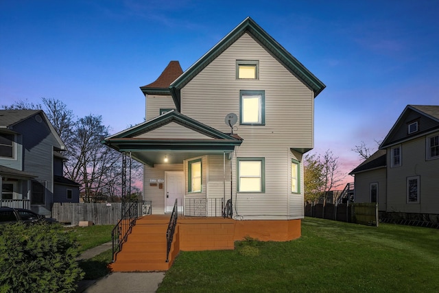 exterior space featuring covered porch and a lawn