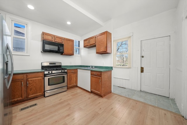 kitchen featuring sink, light hardwood / wood-style floors, and appliances with stainless steel finishes