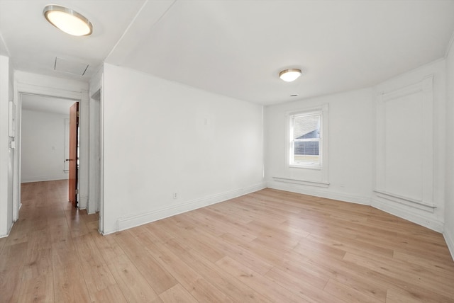 spare room featuring light wood-type flooring