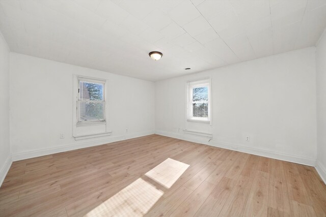 unfurnished room featuring light wood-type flooring and a wealth of natural light