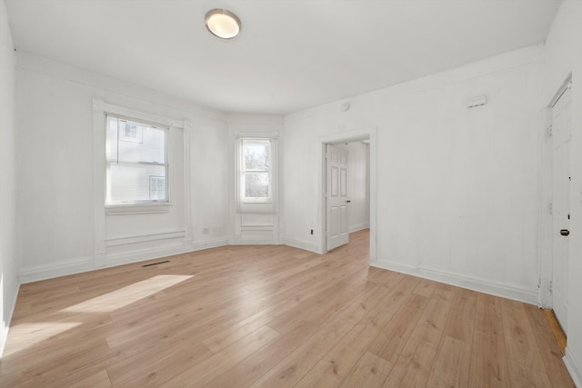 empty room with light hardwood / wood-style flooring