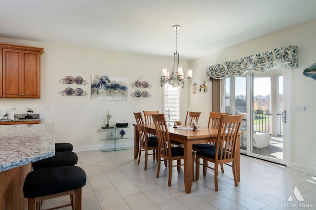 dining room with a notable chandelier and light tile patterned flooring