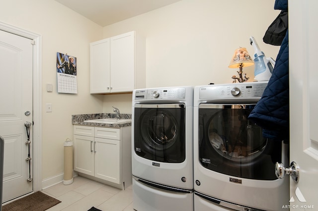 laundry room featuring cabinets, light tile patterned floors, separate washer and dryer, and sink