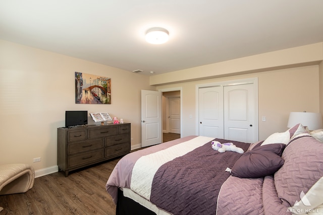 bedroom with a closet and dark hardwood / wood-style flooring