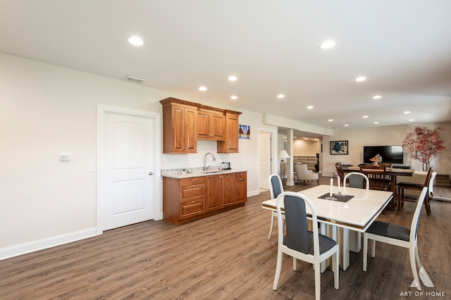 dining space featuring wood-type flooring and sink