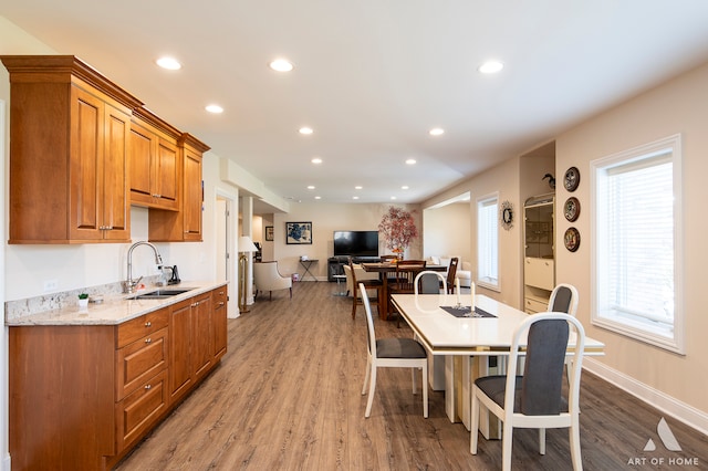 dining space featuring sink and wood-type flooring