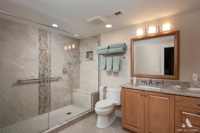 bathroom featuring vanity, toilet, and walk in shower