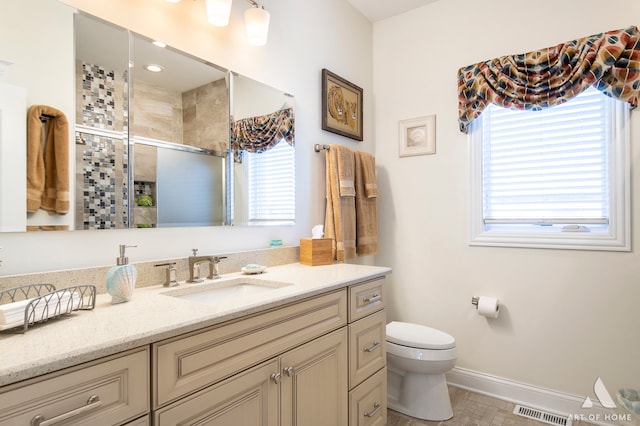 bathroom with vanity, toilet, and an enclosed shower