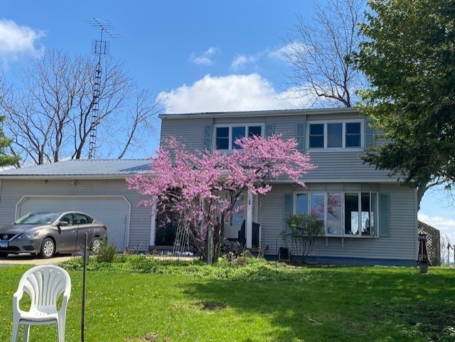 1522 E 7th Rd, Lostant, IL 61334 - traditional home with a front yard and a garage