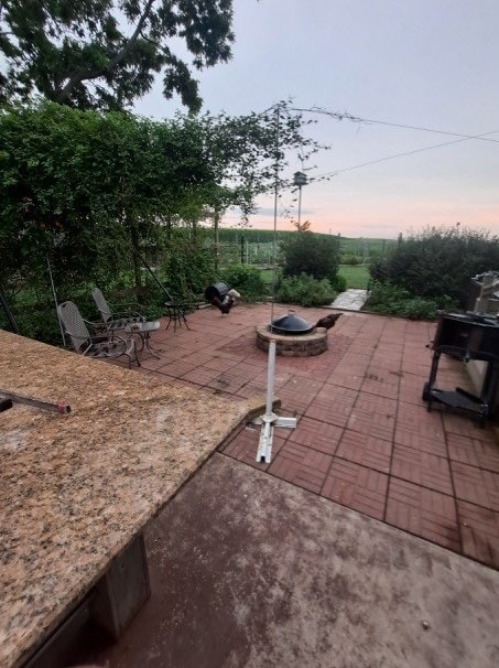 1522 E 7th Rd, Lostant, IL 61334 - patio terrace at dusk with a fire pit