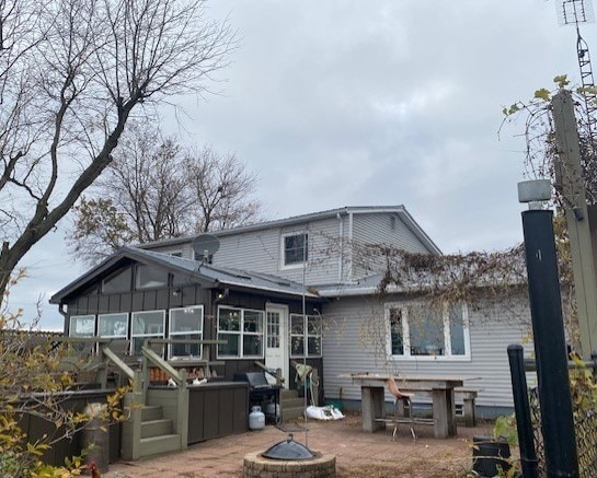 1522 E 7th Rd, Lostant, IL 61334 - back of house featuring a patio, an outdoor fire pit, and a wooden deck