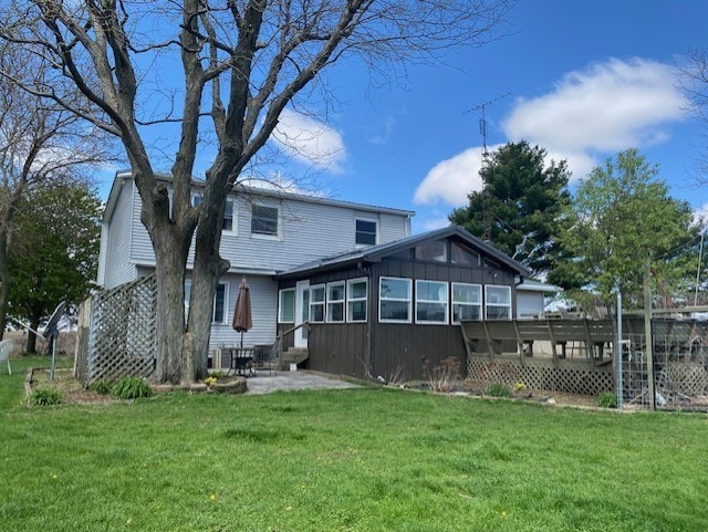 1522 E 7th Rd, Lostant, IL 61334 - back of property featuring a yard, entry steps, and a patio area