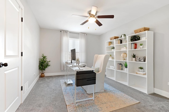 carpeted home office with ceiling fan