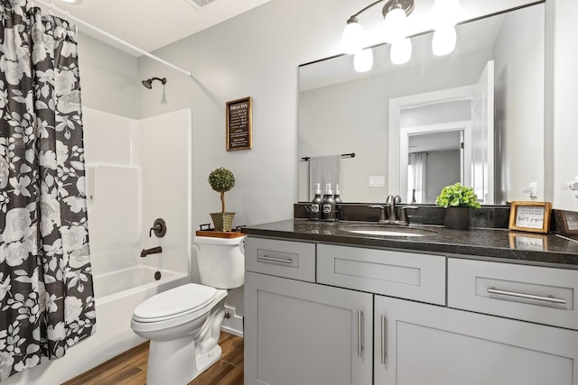 full bathroom with wood-type flooring, vanity, toilet, and shower / tub combo with curtain