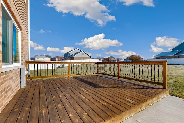 wooden deck featuring a lawn