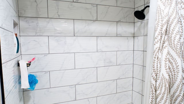 bathroom with tiled shower