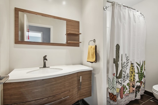 bathroom with toilet, a shower with curtain, vanity, and tile patterned floors