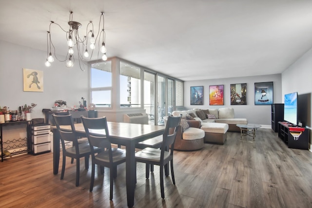 dining area with hardwood / wood-style floors and a notable chandelier