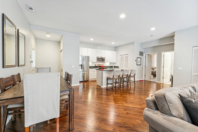 dining area with dark hardwood / wood-style flooring and sink