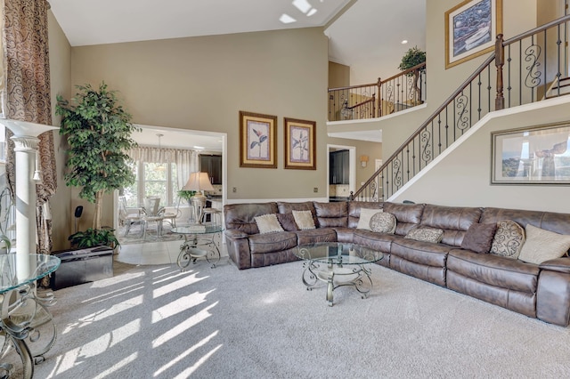 carpeted living room featuring a high ceiling