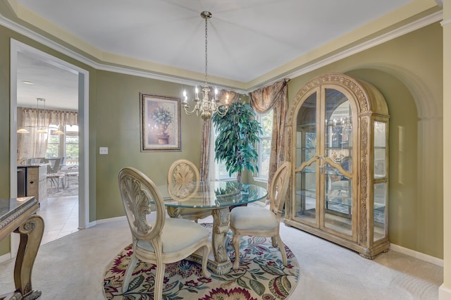 carpeted dining room with an inviting chandelier and ornamental molding