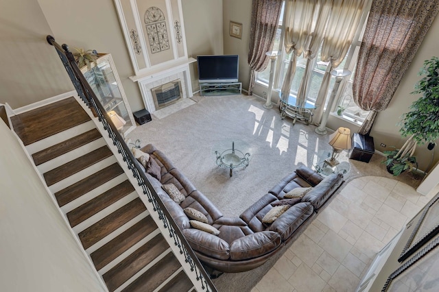 carpeted living room with a tiled fireplace