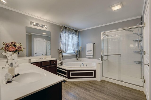 bathroom featuring crown molding, hardwood / wood-style floors, vanity, and shower with separate bathtub