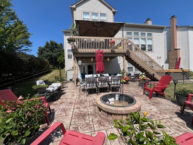 back of house with an outdoor fire pit, a patio area, and a wooden deck