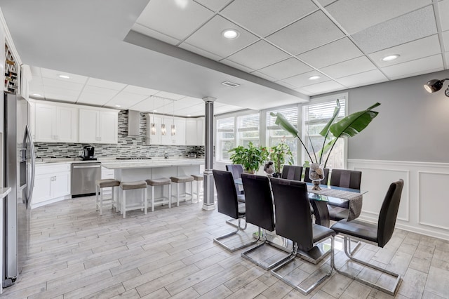 dining space featuring a paneled ceiling