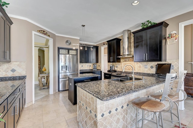 kitchen with sink, wall chimney range hood, stainless steel fridge with ice dispenser, pendant lighting, and a kitchen island