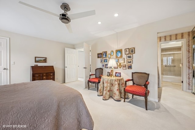 carpeted bedroom featuring ensuite bathroom and ceiling fan