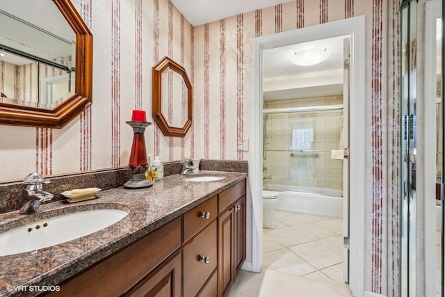 full bathroom with tile patterned floors, toilet, vanity, and combined bath / shower with glass door