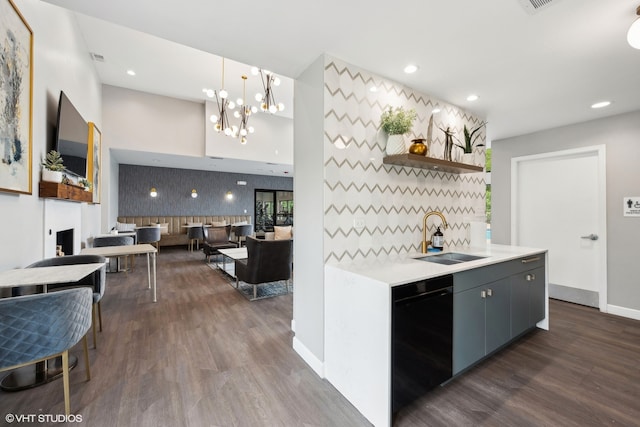 kitchen with dark hardwood / wood-style flooring, sink, pendant lighting, a chandelier, and black dishwasher