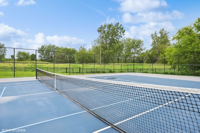 view of tennis court featuring basketball court