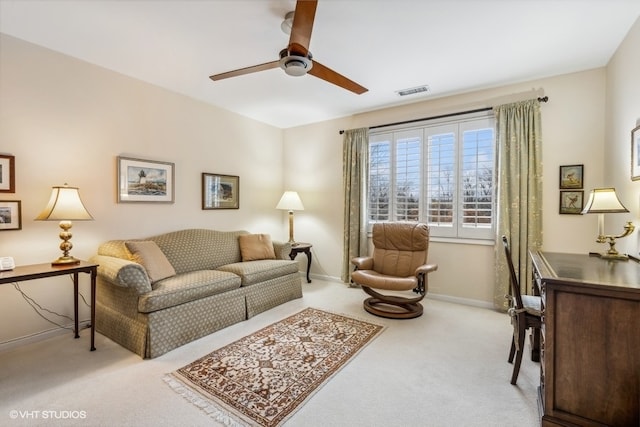 living room with ceiling fan and light colored carpet