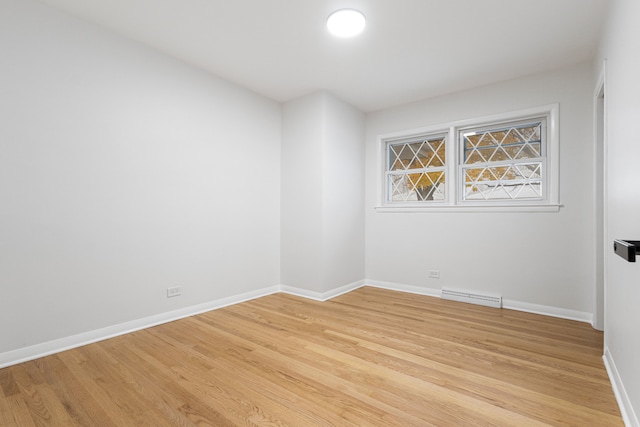 unfurnished room with light wood-type flooring